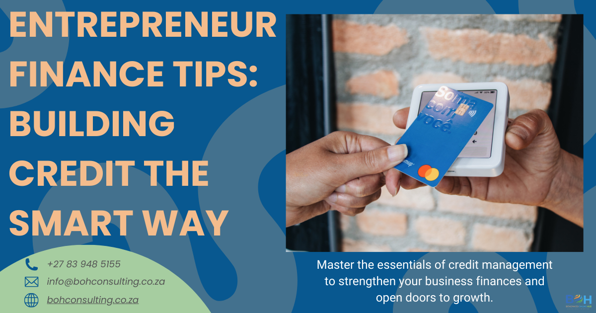 Entrepreneur utilizing credit card and reviewing finances to build strong business credit.